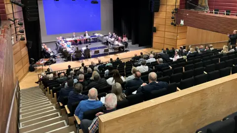 People watch as the public inquiry into the A5 upgrade takes place inside the Strule Arts Centre