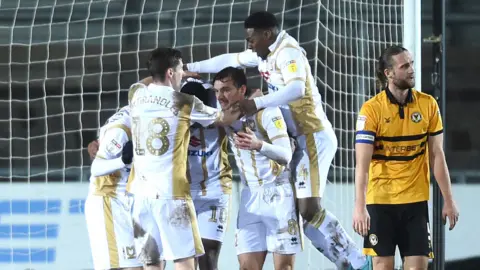MK Dons players celebrate