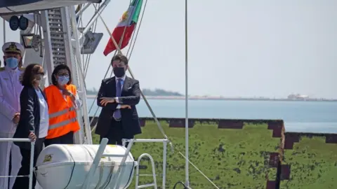EPA Italian Prime Minister Giuseppe Conte stands on the deck of a boat of the Italian Coast Guard