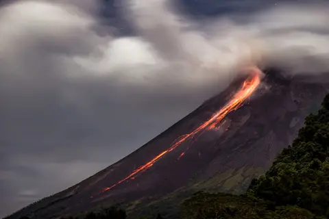Garry Lotulung / AFP Lava flows from the crater of Mount Merapi, Indonesia's most active volcano