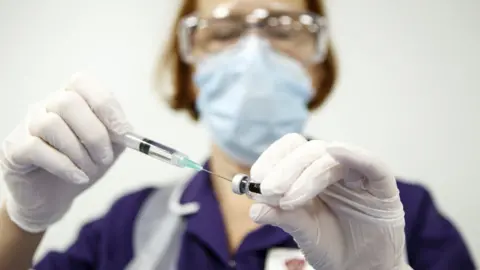 PA Media A vaccine is prepared