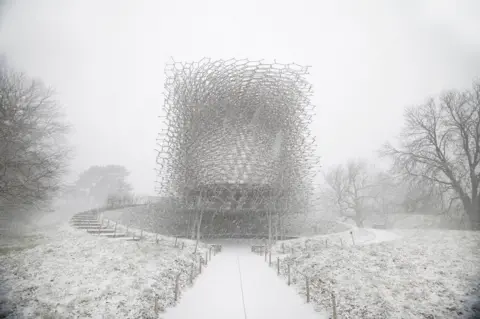 Jeff Eden / APA18 A snowy landscape with a honeycomb-style metal building
