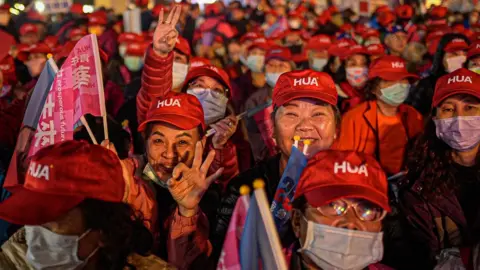 Women waving flags at the KMT rally