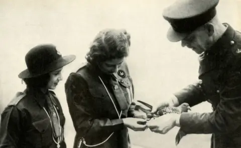 Getty Images Princess Elizabeth and her younger sister Princess Margaret Rose send a message by carrier pigeon to Lady Baden-Powell on her birthday 20 February 1943