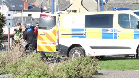 Hazel Christopher Police loading things into a van