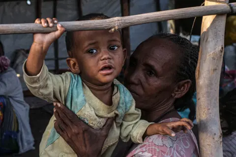 Byron Smith / Getty Images Refugees from the Tigray region of Ethiopia wait to be transferred to a camp