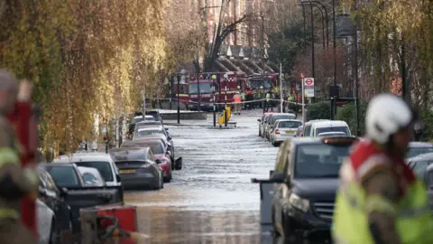 PA Media Flooded street and fire crews at the scene