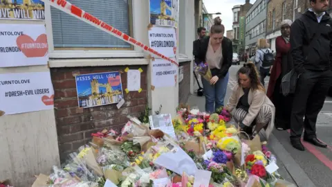 PA Floral tributes have been building up at a number of locations around the scene of the attack