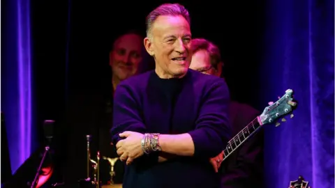 Getty/Jason Mendez NEW YORK, NEW YORK - NOVEMBER 30: Bruce Springsteen attends the "Love For The Holidays" concert at Town Hall on November 30, 2023 in New York City