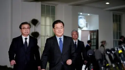 AFP South Korean National Security Advisor Chung Eui-yong (C) and South Korea National Intelligence Service chief Suh Hoon (L) make their way to brief reporters outside the West Wing of the White House on March 8, 2018 in Washington, DC