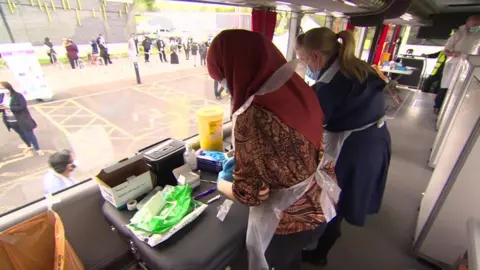 BBC Women on bus prepare Covid vaccinations