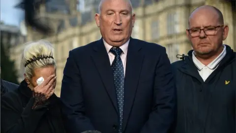 Getty Images Charlotte Charles, Radd Seiger and Tim Dunn outside the Houses of Parliament