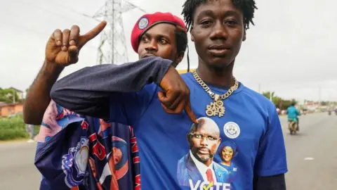 Reuters Supporters of the leader of Liberia's ruling party Coalition for Democratic Change (CDC), President and former soccer player George Weah, react as they arrive to his final campaign rally for the presidential elections in Monrovia, Liberia October 8, 2023.