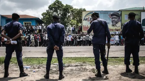 AFP Police stand in front of supporters of Democratic Republic of Congo opposition leader and presidential candidate Martin Fayulu as they take part in a protest to contest presidential election results in Kinshasa on 11 January 2019