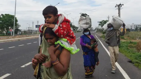 Getty Images Thousands of people have walked long distances to reach their villages after the shutdown