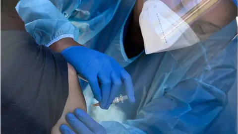 Getty Images A person is vaccinated in the US