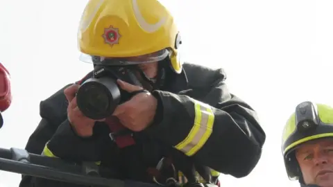 South Yorkshire Fire and Rescue Tim taking a photo