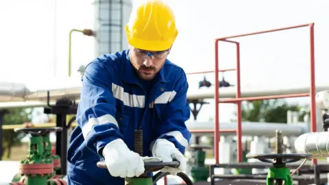 Getty Images Worker at refinery