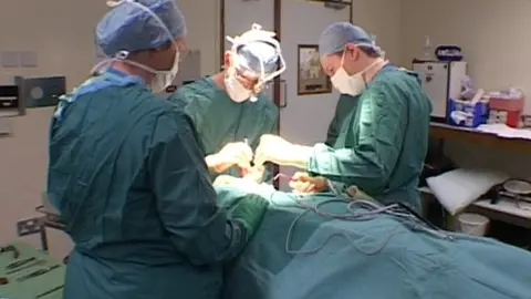 Still of Graeme Perks working, taken from East Midlands Today