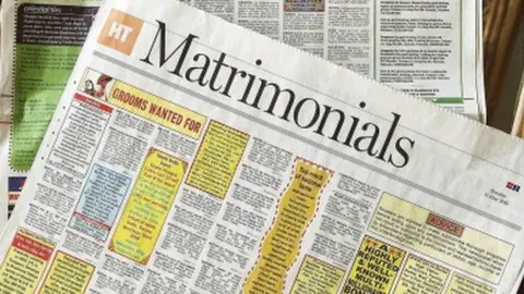 Getty Images All Indian newspapers publish pages of matrimonials where families are looking for a bride or a groom for their child according to a cast, a religion, a social status, etc. T