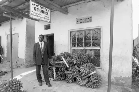 Mwine Photographer outside his studio