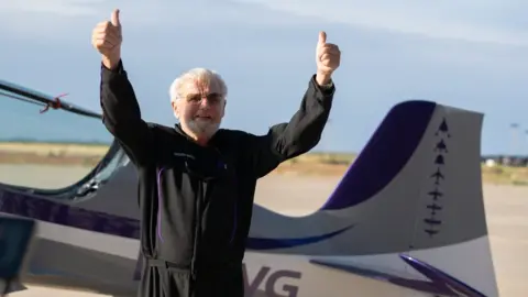 Jon Goodwin gives a thumbs up after completing G-force training before his flight