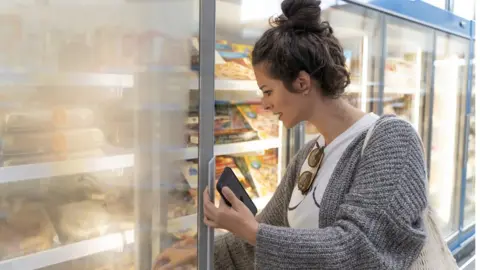Getty Images Woman buying frozen food
