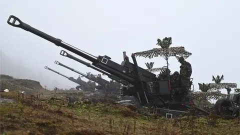 AFP Indian Army soldiers are pictured on a Bofors gun positioned at Penga Teng Tso ahead of Tawang, near the Line of Actual Control (LAC), neighbouring China, in India's Arunachal Pradesh state on October 20, 2021.
