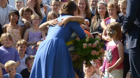 EPA The duchess met children, who greeted her with hugs in Berlin