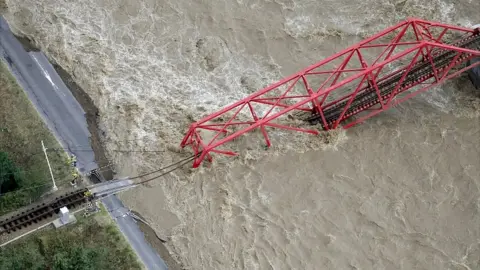 Reuters A collapsed railway bridge is seen over Chikuma river swollen by Typhoon Hagibis in Ueda, central Japan, October 13, 2019