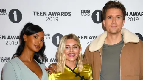 Getty Images Maya Jama with Radio 1 presenters Mollie King and Greg James