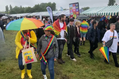 BBC People with umbrellas at Pride on Saturday