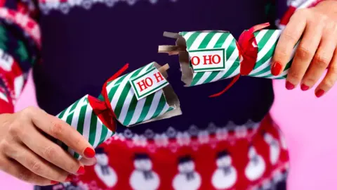 Getty Images Woman pulling cracker