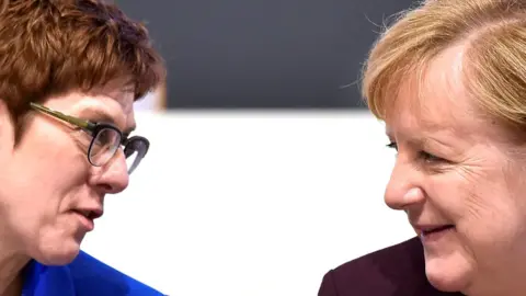 Reuters German Chancellor Angela Merkel (R) talks to party chairwoman Annegret Kramp-Karrenbauer during the Christian Democratic Union (CDU) party congress in Leipzig, Germany, 22 November 2019