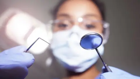 Dentist attends to a patient