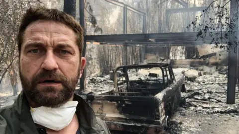 @GerardButler Gerard Butler in front of his fire-ravaged home