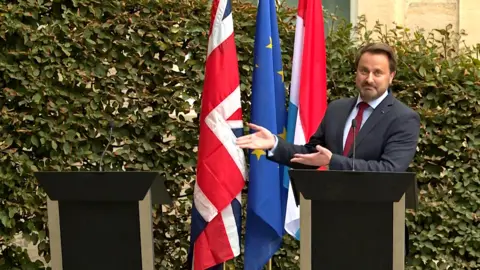 Kilian Fichou/AFP Luxembourg's Prime Minister Xavier Bettel gestures to an empty podium as he speaks to the press after meeting the UK Prime Minister in Luxembourg. 16 September 2019