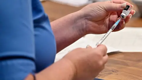 Getty Images A nurse with a Covid vaccination