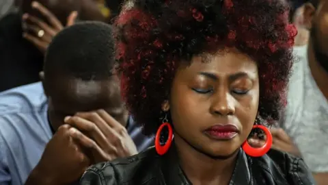 AFP Relatives of Kenyan victims light candles during a memorial service at the Kenyan Embassy in Addis Ababa on 16 March 2019.