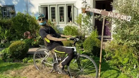 Jayne Garland Scarecrow sitting on bicycle