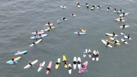 Surfers in a circle in the water