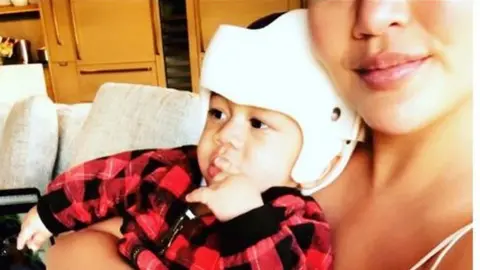 Chrissy Teigen Chrissy Teigen posted a picture of her son on Instagram wearing a skull shaping helmet.