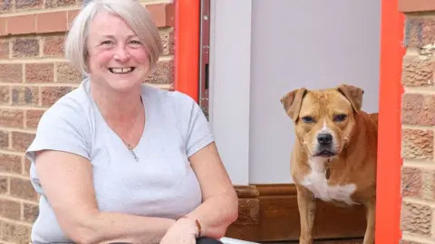 Dogs Trust Christine Drysdale a Leeds foster carer, with Staffordshire bull terrier, Belle