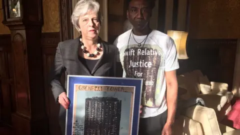 Relative Justice Humanity for Grenfell/PA Damel Carayol with Theresa May