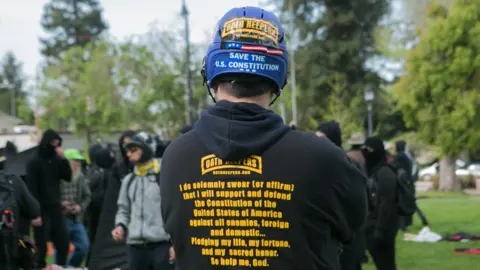 Getty Images A man in an Oath Keeper hoodie and a helmet