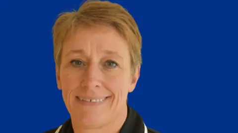Kettering General Hospital Woman with short fair hair wearing a nurse's uniform