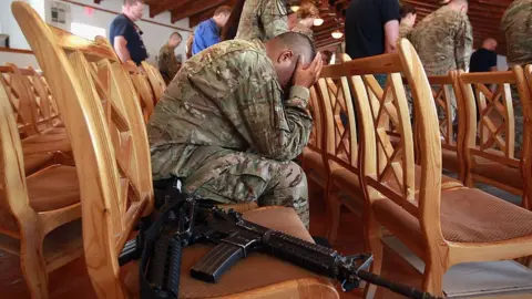 Getty Images An American soldier holds his head during prayers on September 11, 2011 at Bagram Air Field