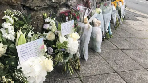 PA Media Floral tributes