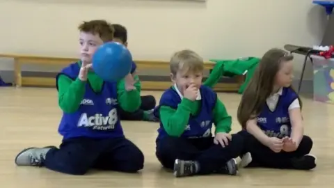 Primary school pupils sitting down