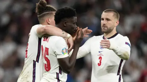 EPA Bukayo Saka with team-mates Kalvin Phillips and Luke Shaw